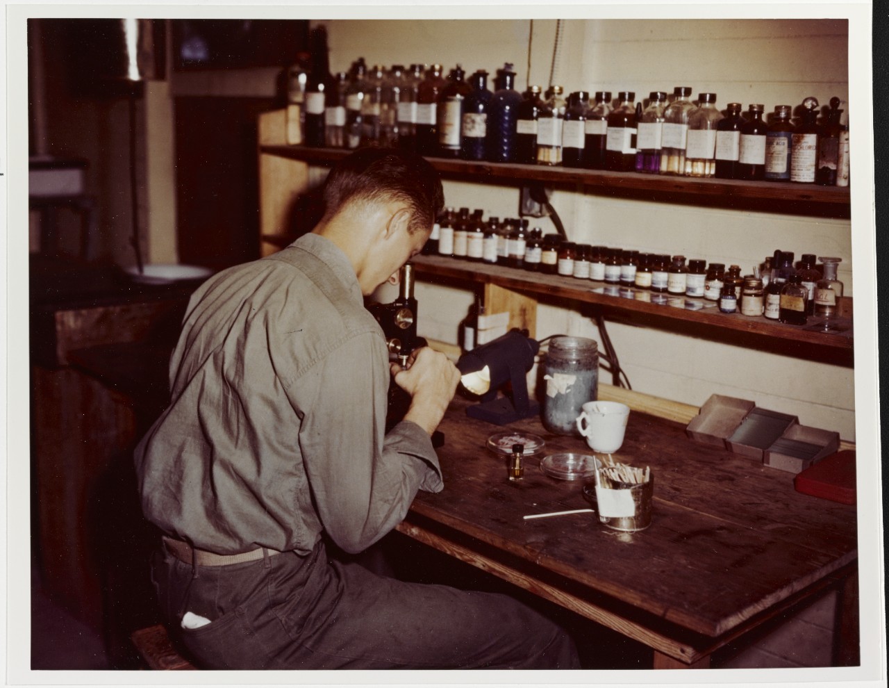 Agana, Guam, Civilian Hospital U.S. Navy Hospital Corpsman examines blood specimen, 1944-1945