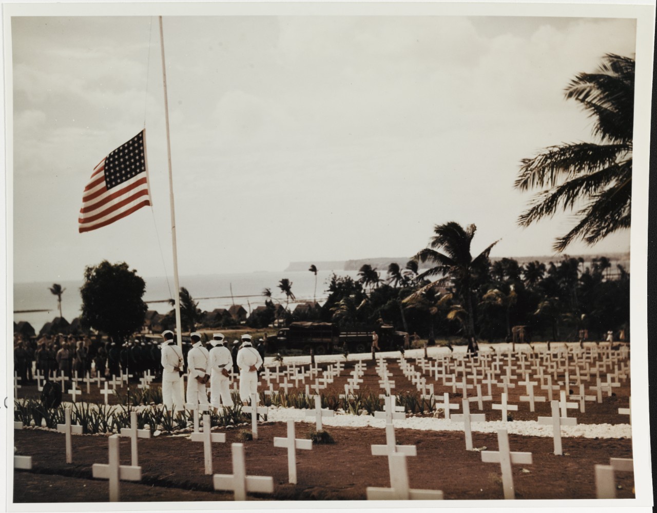 Agat Cemetery, Guam. Navy Color Guard stands by the half-masted flag, during Memorial Day ceremonies, 30 May 1945