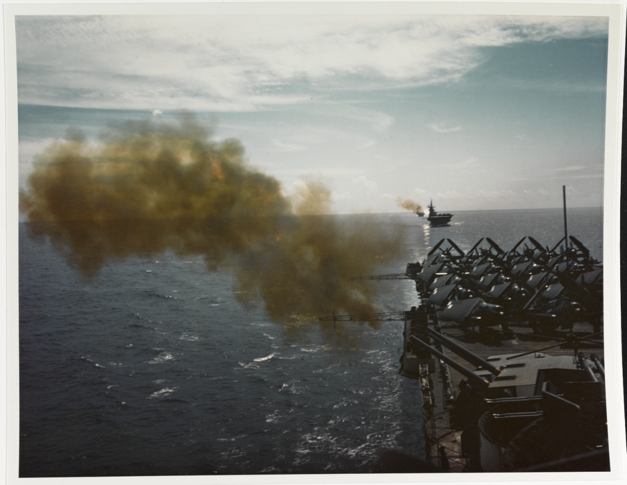 USS HORNET (CV-12) Firing gun battery in Western Pacific, circa June 1945