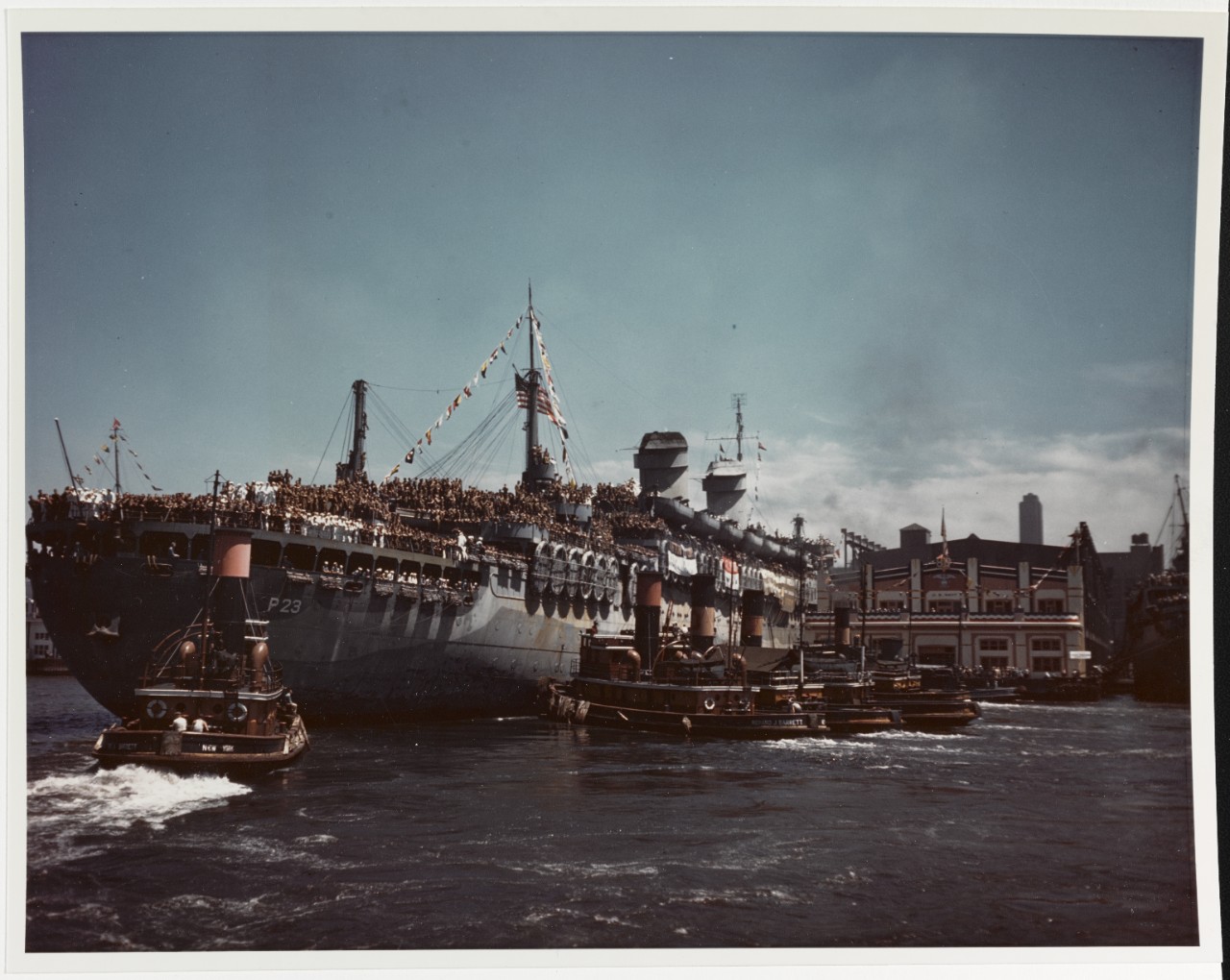 USS WEST POINT (AP-23) Docking at a Navy Pier, New York City, 11 July 1945