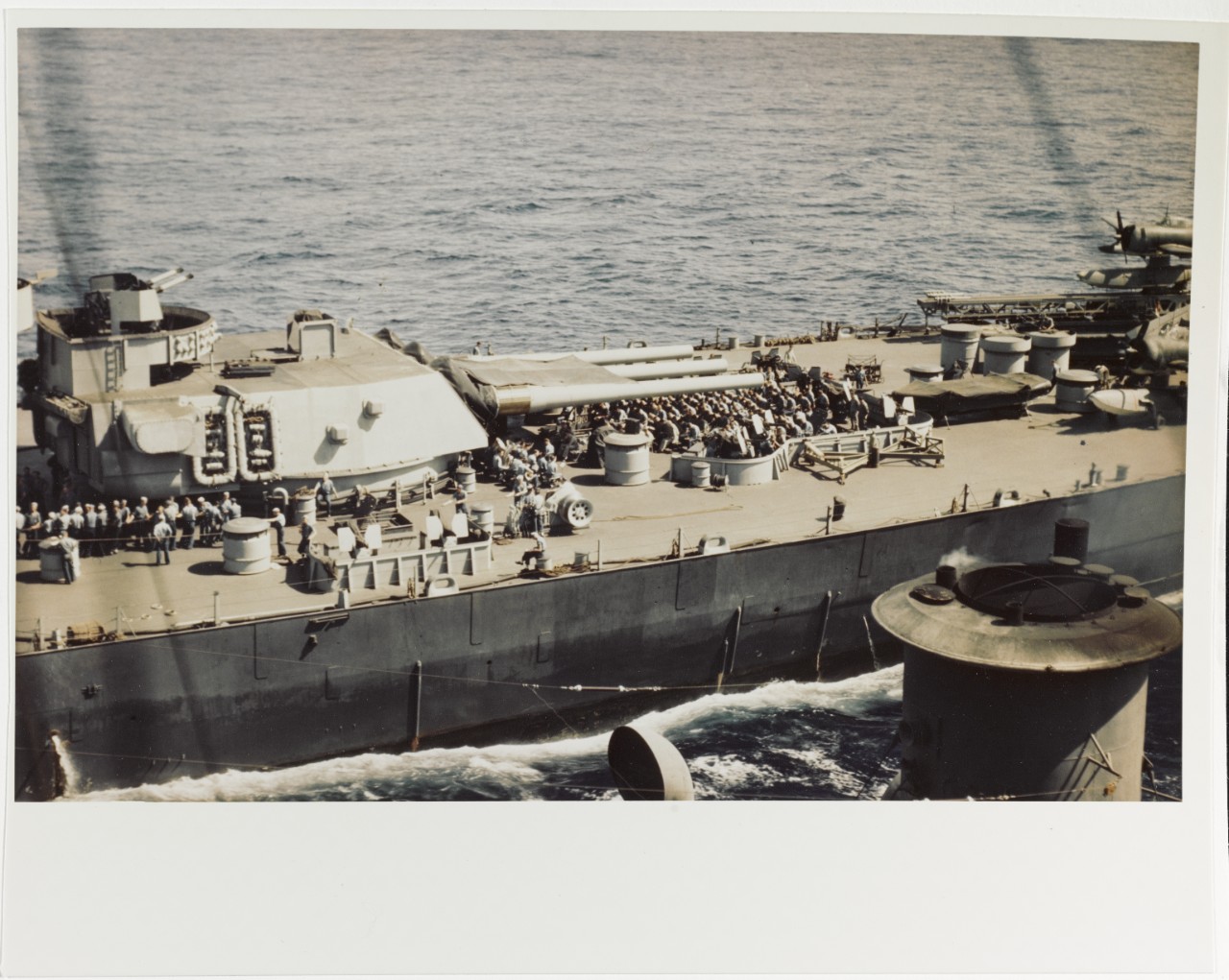 USS IOWA (BB-61) Crewmen at divine services aft of No. 3 16"/50 turret, 1945