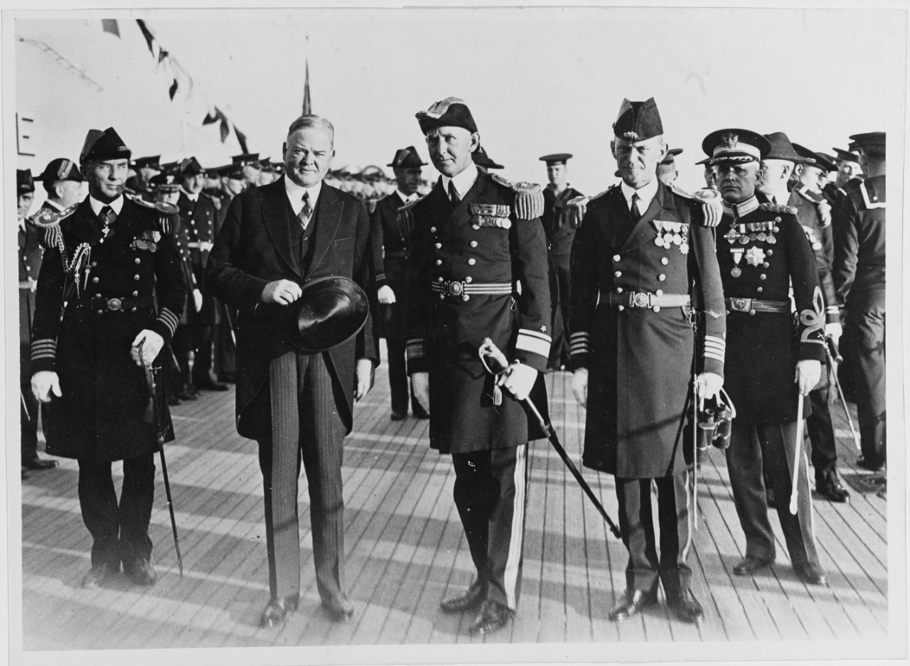 Captain Russell Train, USN, Aide to President; President Herbert Hoover; Rear Admiral Claude C. Bloch, USN; Captain Percy Foote, USN; and President's Military Aide.