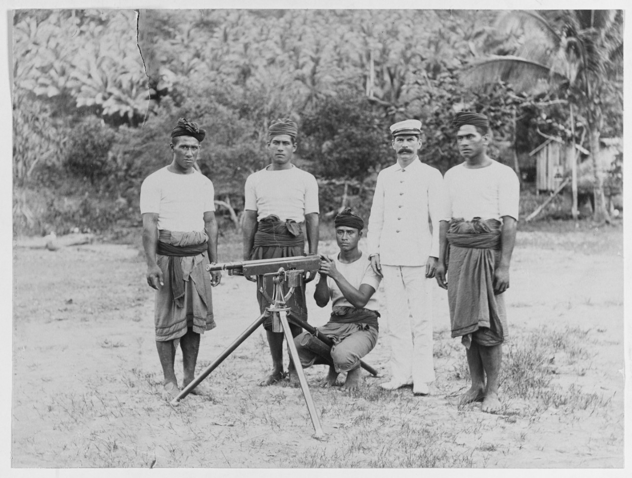 Native guard with Colt gun, Samoa, 1900-1901.