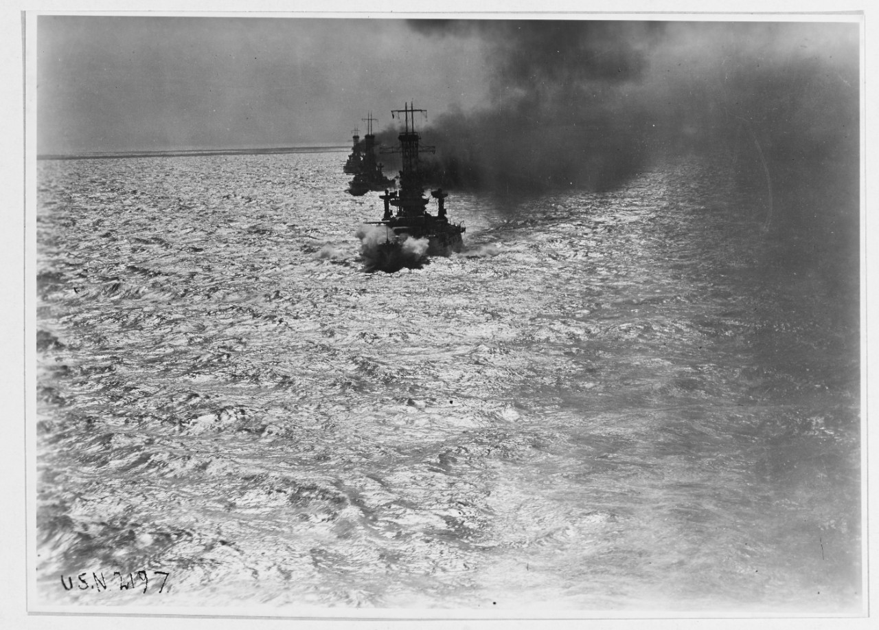 Distant "bow on" view of a battleship formation at sea in 1921.