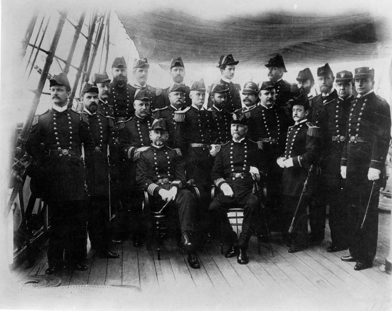 Officers of USS Chicago (protected cruiser) circa 1893-1895. Captain Alfred T. Mahan is sitting at left, Ensign William A. Moffett is at his left. Image is from the collection of CAPT Bruce Canaga. 