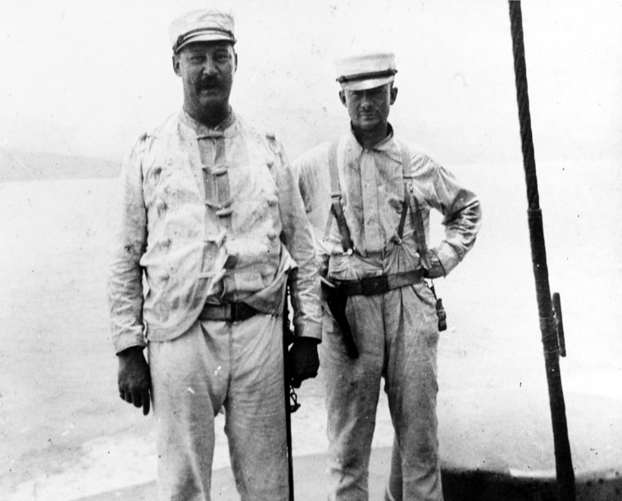 Captain Francis William Dickins and Lieutenant Austin Rockwell Davis, USMC, on deck during Battle of Santiago, July 1898. 