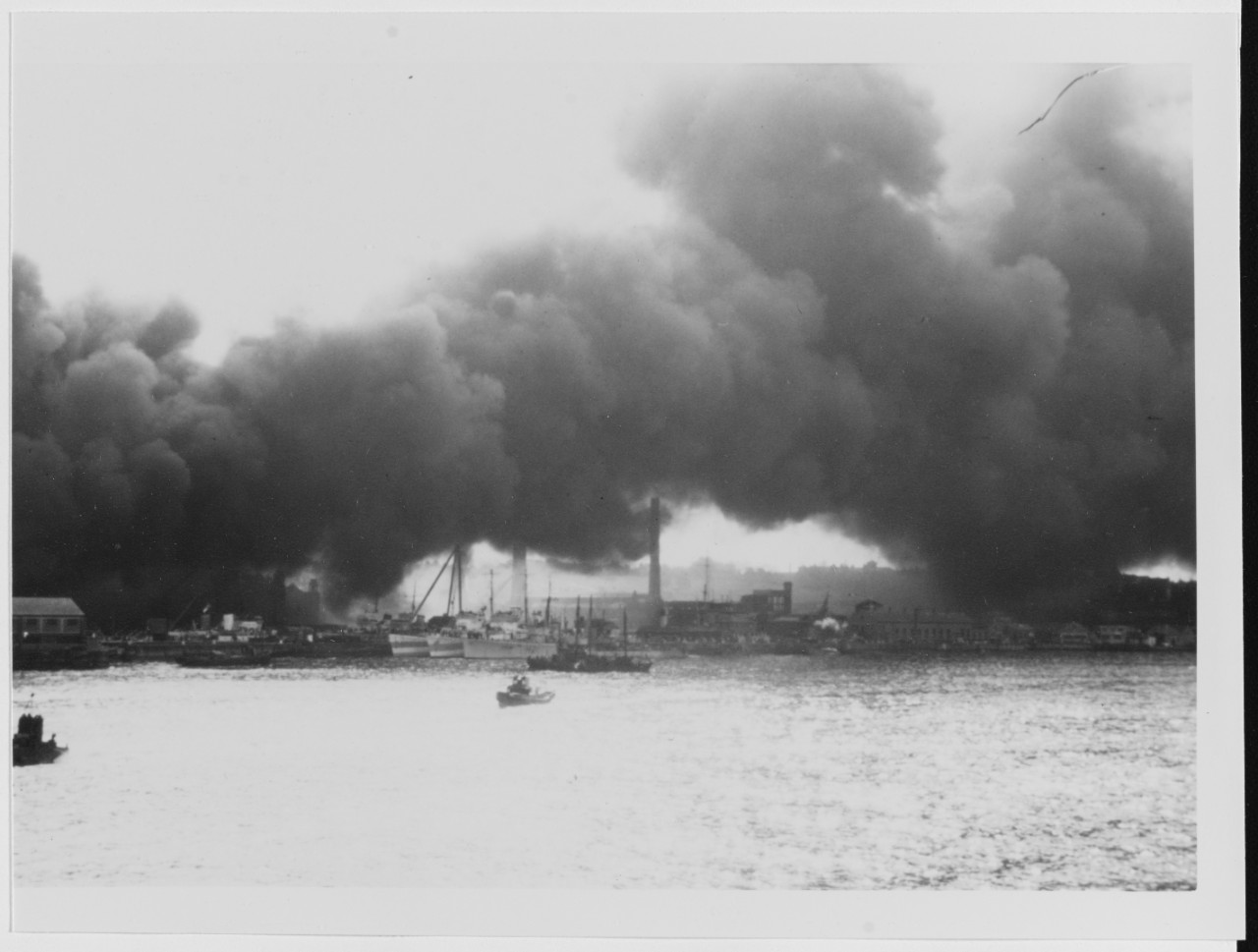 Plymouth, England. Smoke from a  bomb-caused fire in the British Submarine Yard, circa Spring 1944. HMS SCIMITAR (H-21)