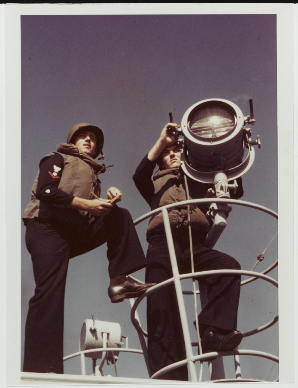 USCGC CAMPBELL (WPG-32). Crewmen signal with a blinker lamp, 1943