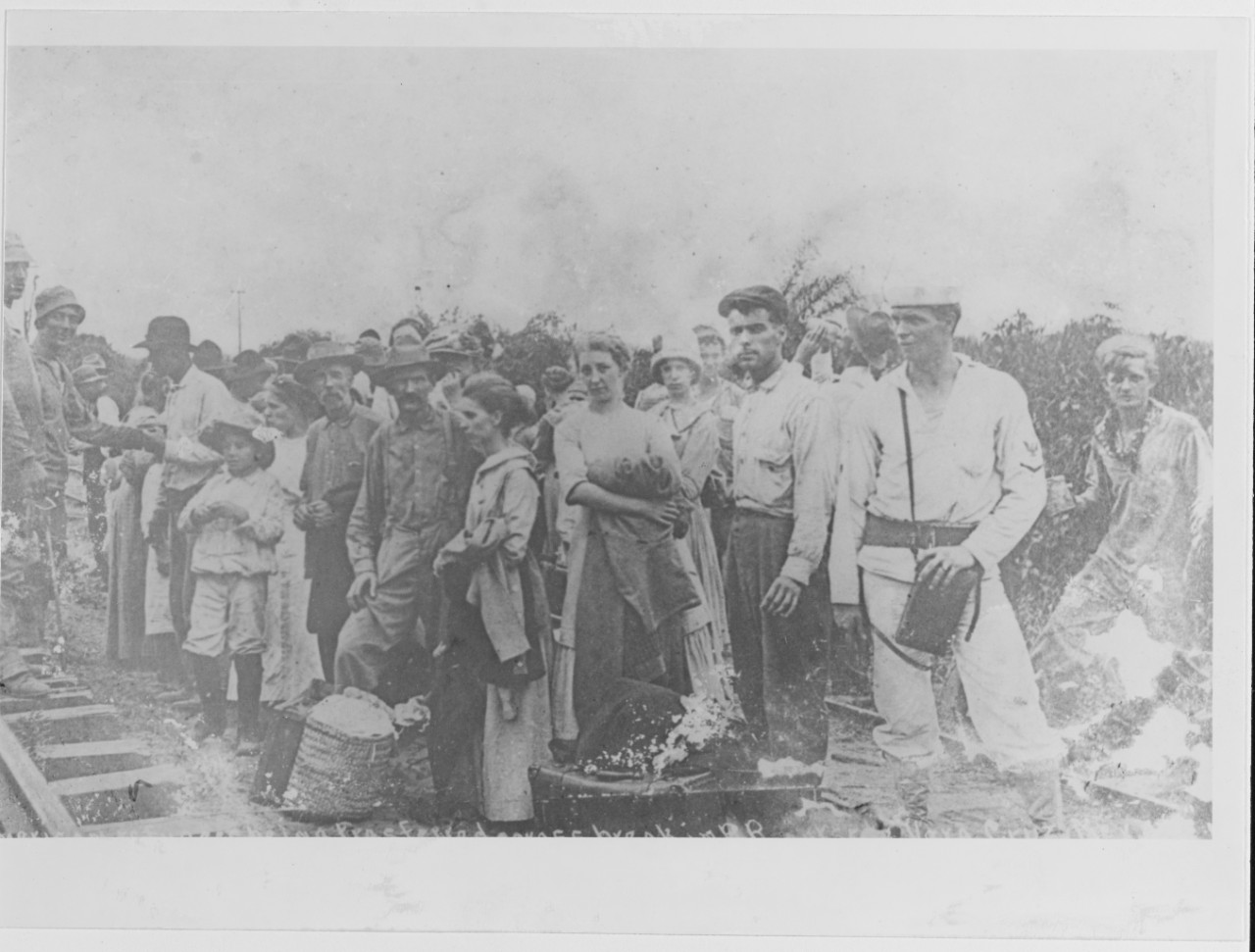 Vera Cruz Incident, 1914. American refugees being escorted across the break in the railroad line, at Vera Cruz, April 1914