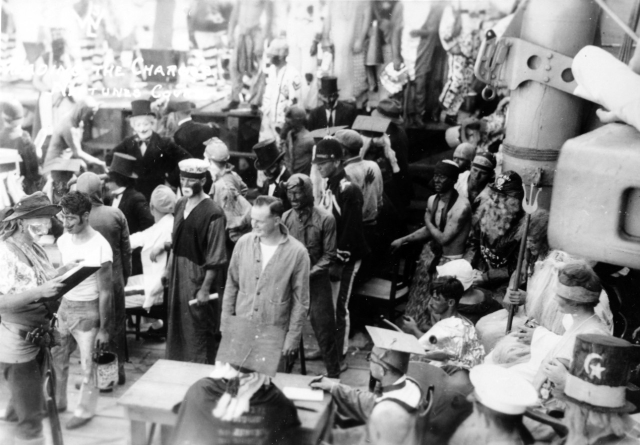 The Royal Court reads the charges against the pollywogs during equator crossing ceremonies (Crossing the Line) on board, circa July 6, 1925. New Mexico was en route to Australia with the US Fleet. From the album of T.G. Siegel. 