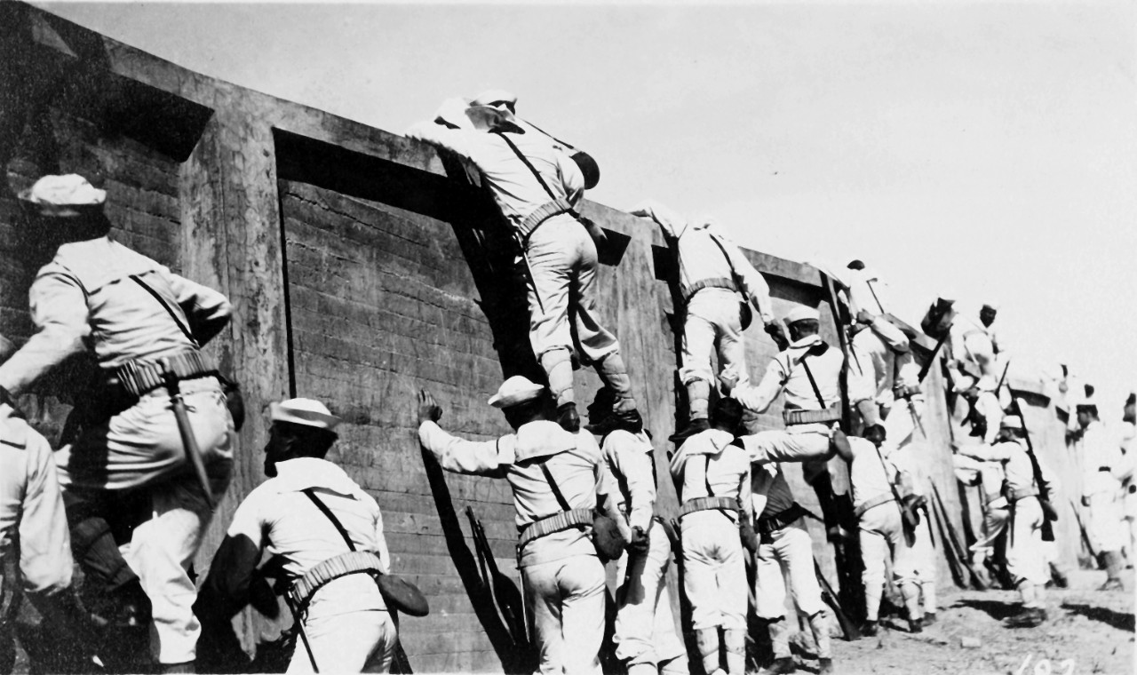 Sailors practice scaling a wall, during landing force drill, circa 1909