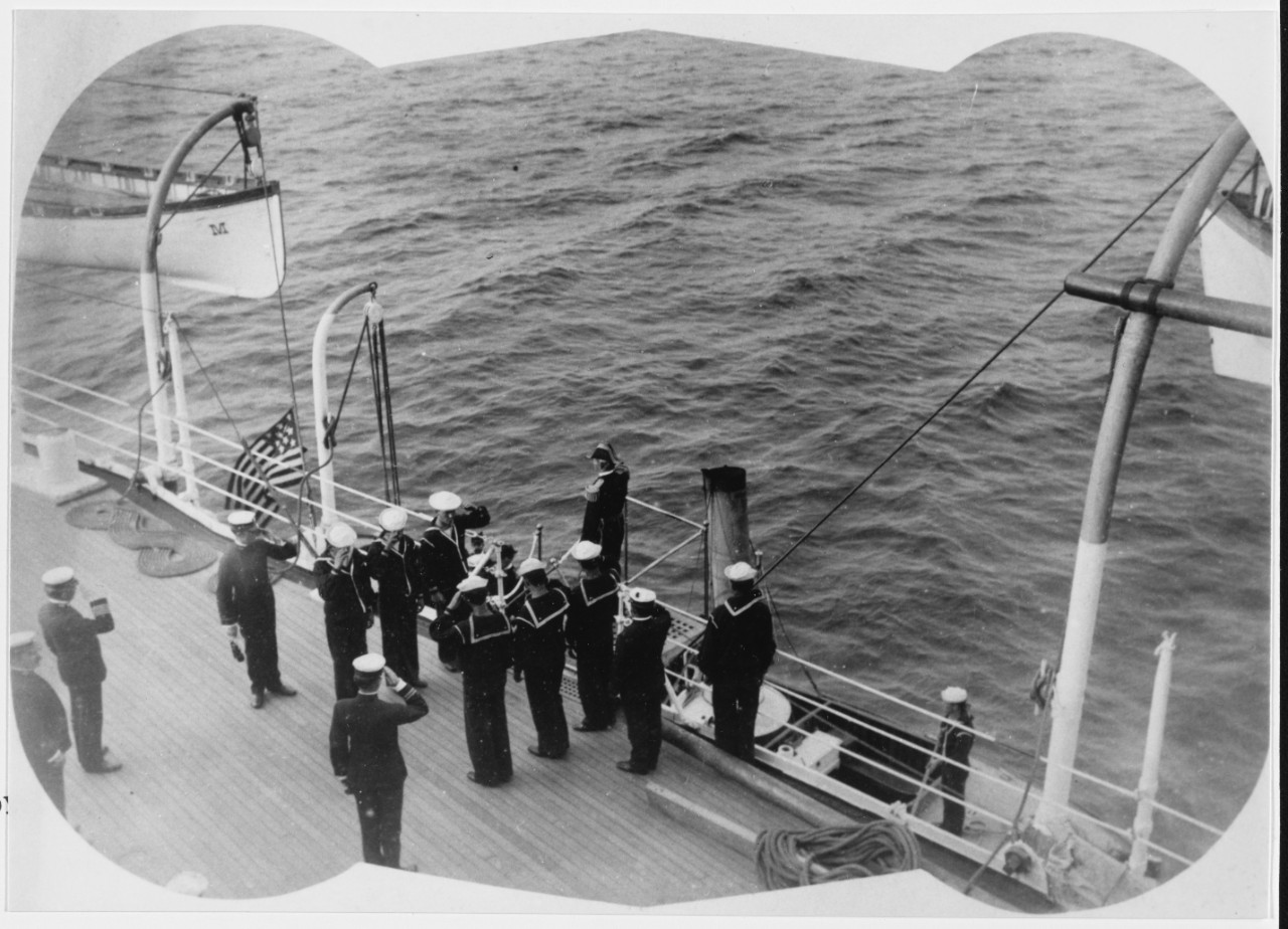 USS MAINE (BB-10) Admiral salutes the Quarterdeck Ensign, as he leaves the ship, circa 1903-1905.