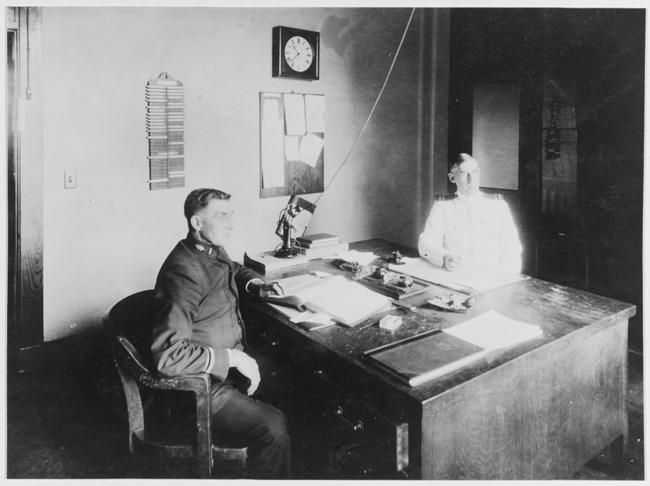 Officers of the day seated at desk. U.S. Naval Hospital, Chelsea, Massachusetts. June 2, 1919.