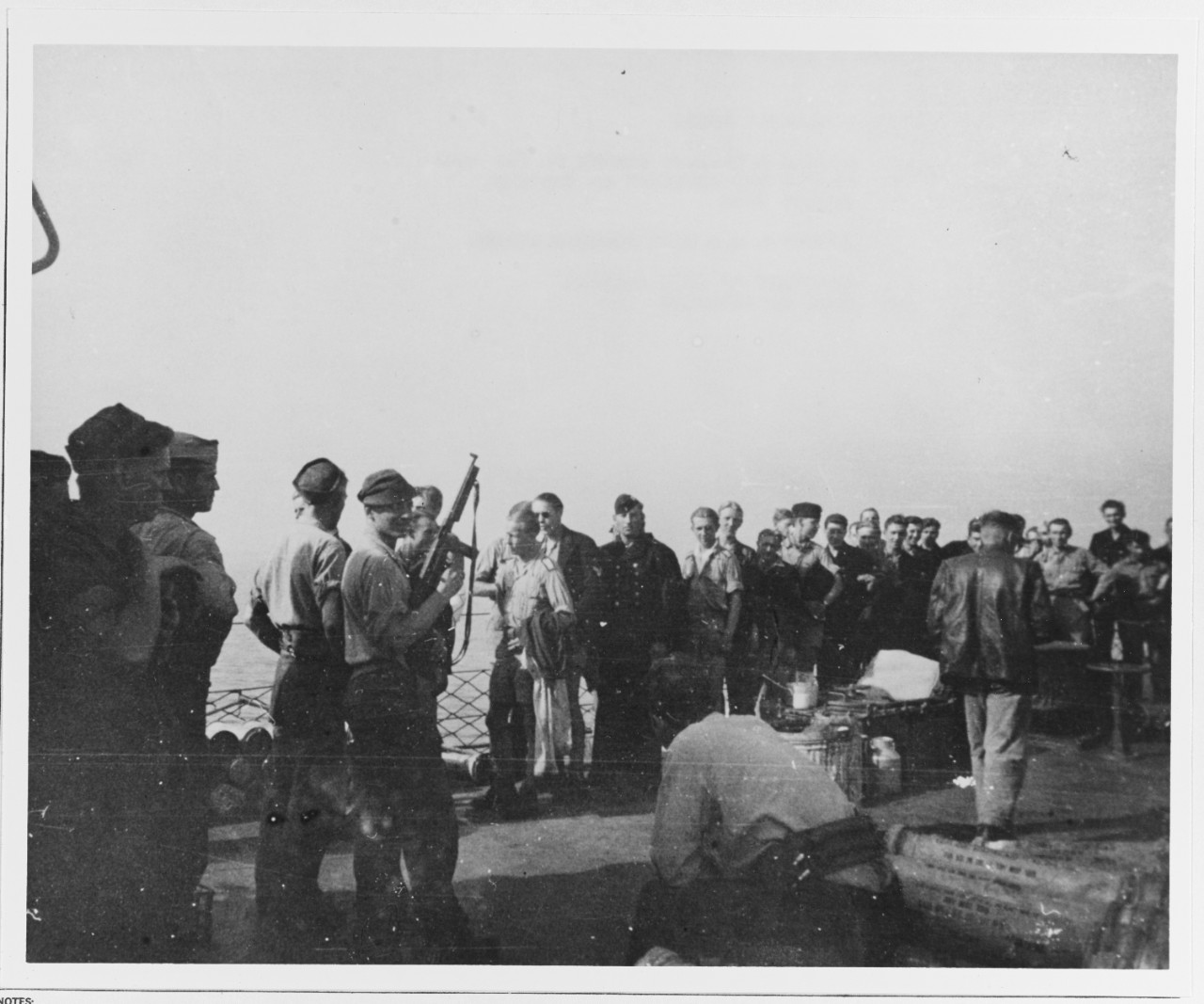 USS ENDICOTT. German prisoners lined up for chow on Foc'sle, August 1944. En route to Toulon, France
