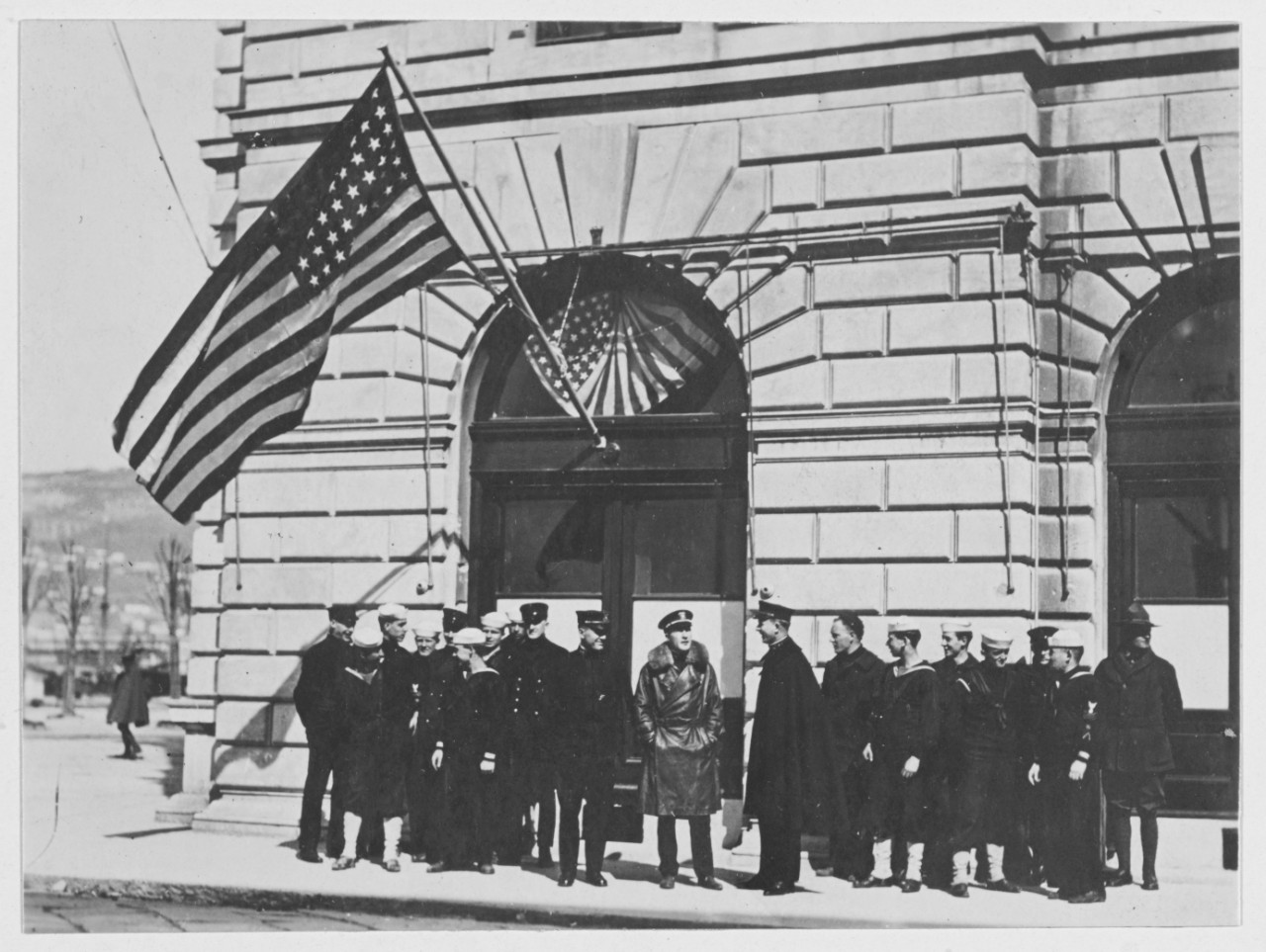 U.S. Navy Officers and men at Headquarters, Trieste, Austria. American flag flies outside building. Austria-Hungary.