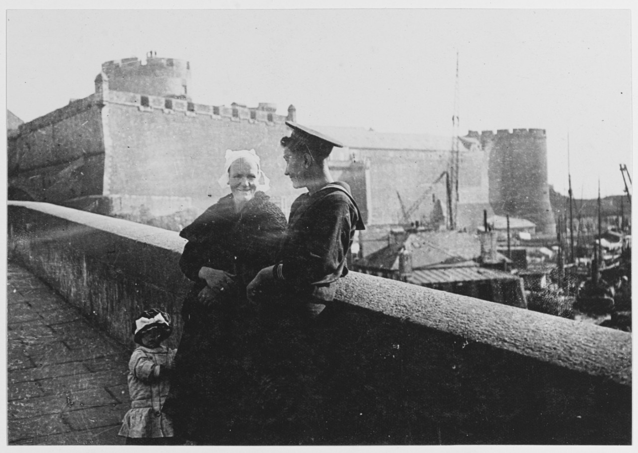 Inhabitant of Brittany and a little girl stand with an American sailor at Brest, France