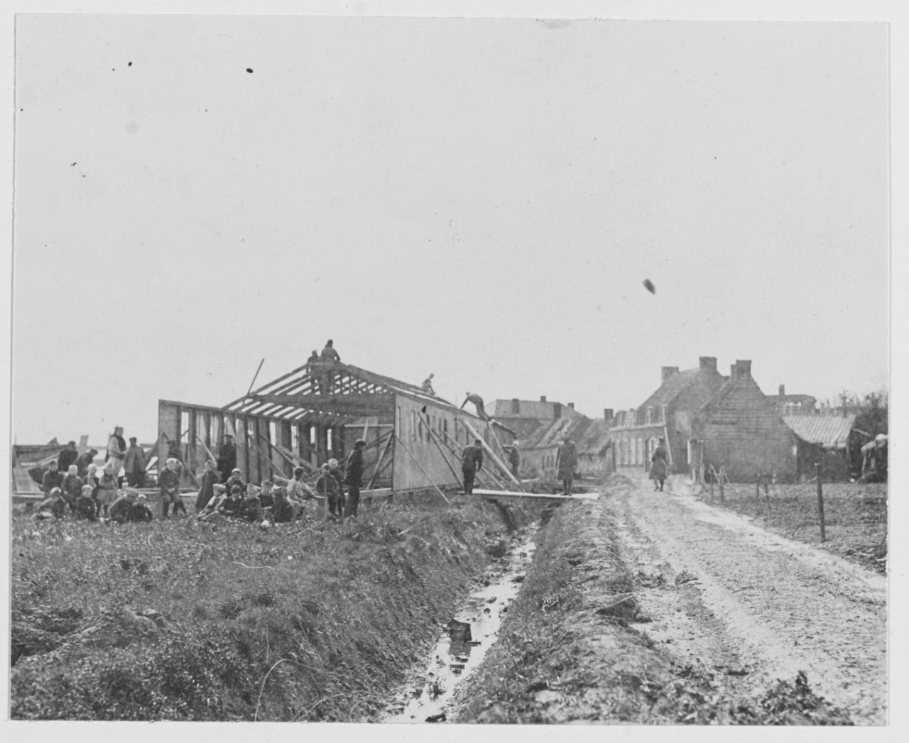 Navy relief work near Lille and Cambrai, France during World War I. Men and building being constructed. 1919
