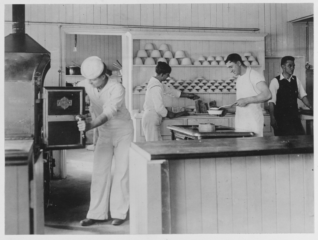 With the American Navy in wartime. U.S. Naval men's club cooks at work.