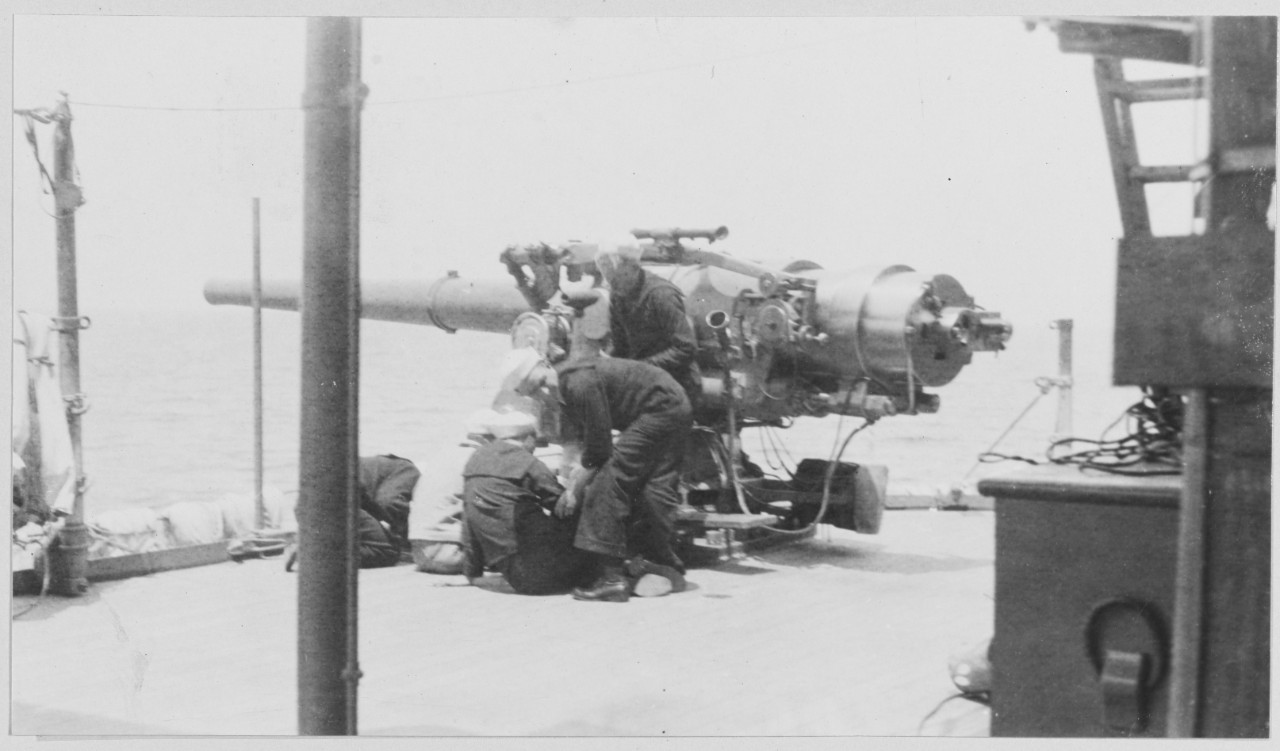 Sailors operating gun on board U.S. Battleship