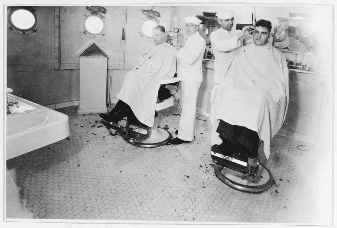 Scene in the barber shop of USS PENNSYLVANIA (BB-38), prior to World War II. 