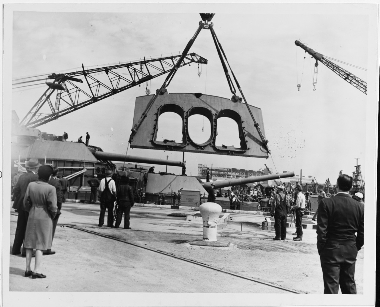 USS PENNSYLVANIA (BB-38) turret faceplate is lifted by a dockyard crane