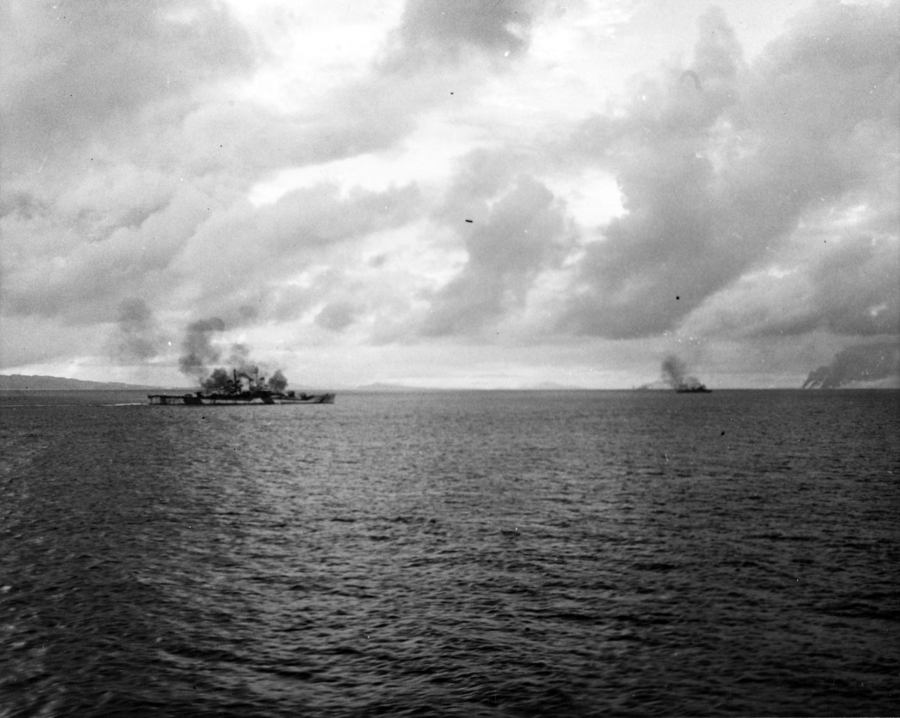 "Enemy DD under fire with burning enemy ships in background"