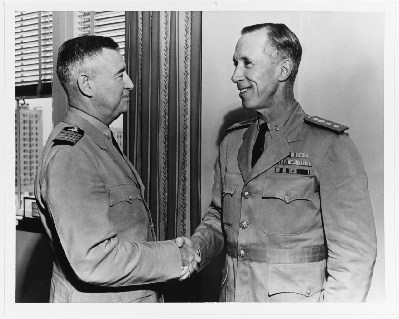 Rear Admiral Walter S. Anderson, USN, greeted by Captain H.H.J. Benson, USN, July 1944.