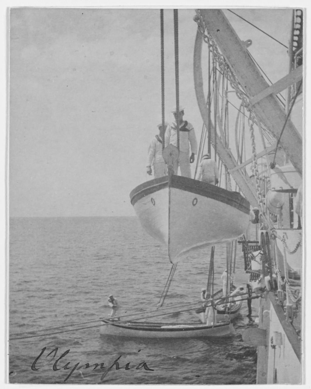 USS OLYMPIA (C-6), one of the ship's boats suspended from davits, 1898. 