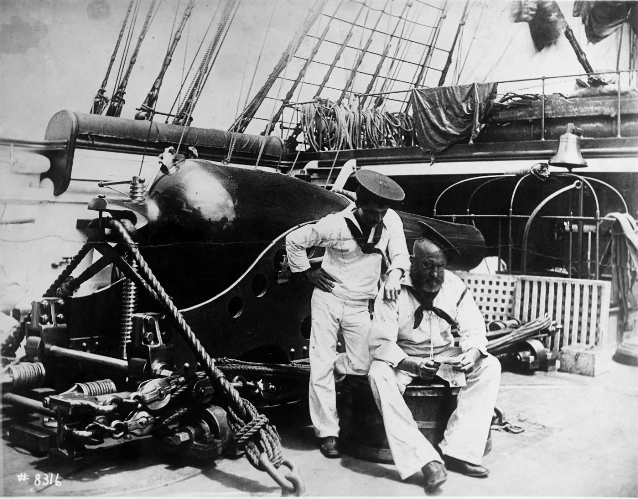 Sailors reading on USS MOHICAN (1885-1922), circa 1887-1888. 
