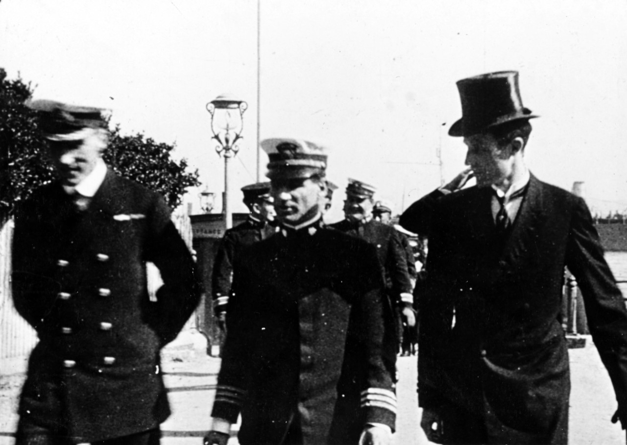 Unidentified British officer, Commander Joseph K. Taussig, USN, and Mr. Wesley Frost, the American Consul