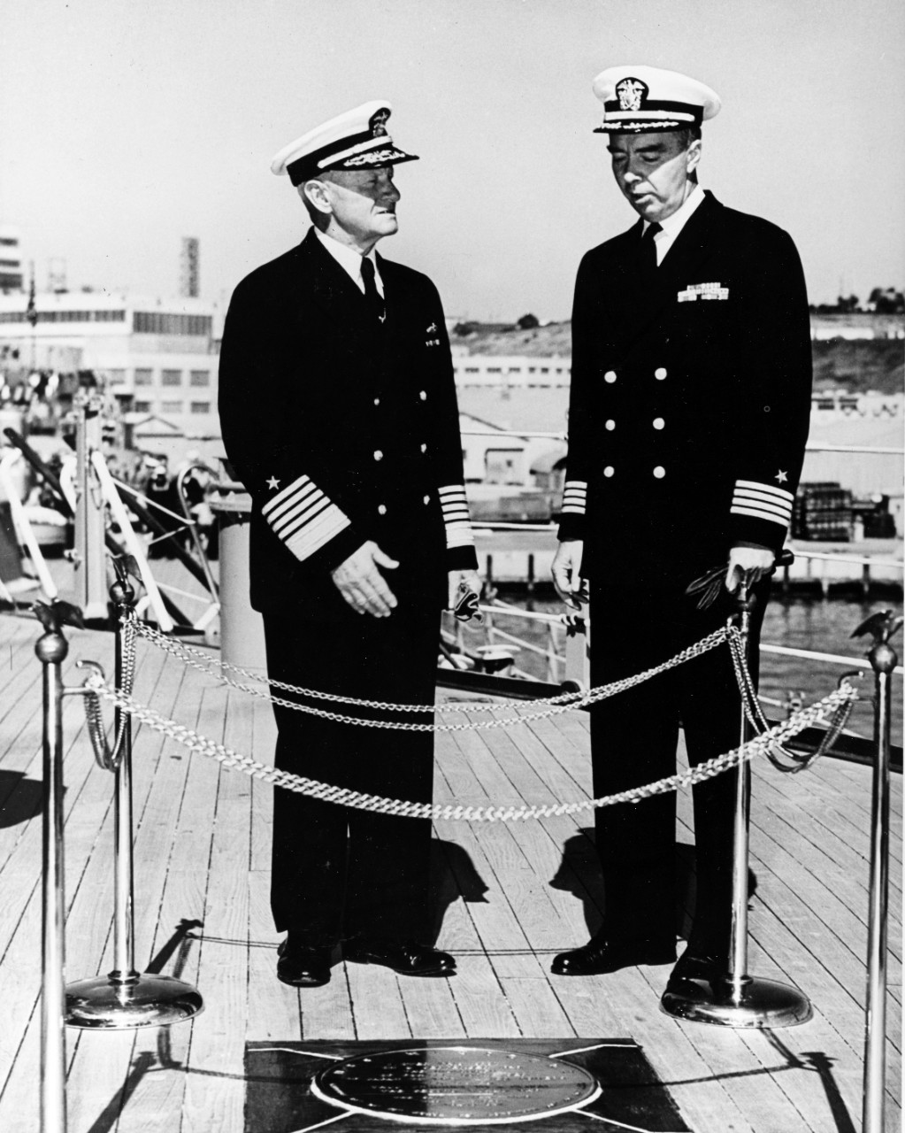 Fleet Admiral Nimitz Revisits USS MISSOURI where the Admiral Stands in Front of a Plaque Marking the Japanese Surrender
