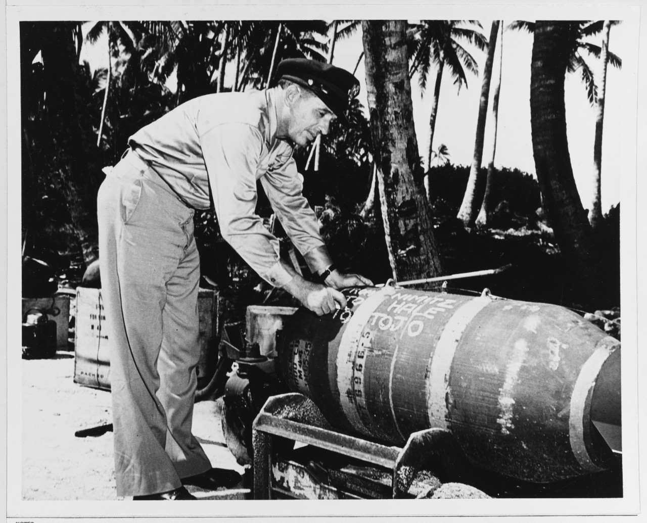 Major General Willis H. Hale writes on a 1000-lb. Demolition Bomb