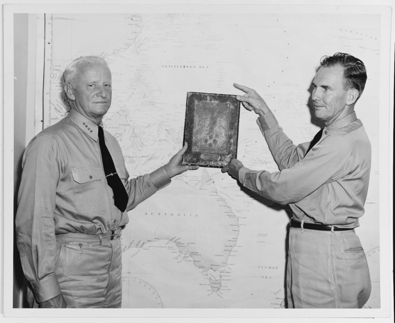 Admiral Nimitz Holding a Trophy which was found among Ruins in Guam