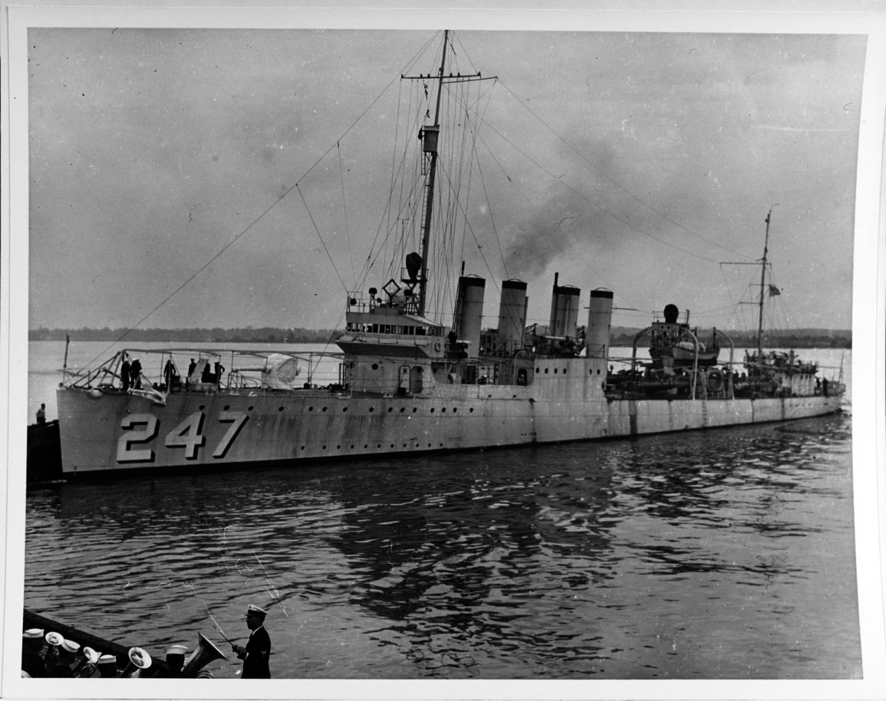 USS Goff (DD-247) backs away from a pier, prior to departing the Philadelphia Navy Yard, Pennsylvania on 5 May 1932. Note the band playing in the lower left foreground. 