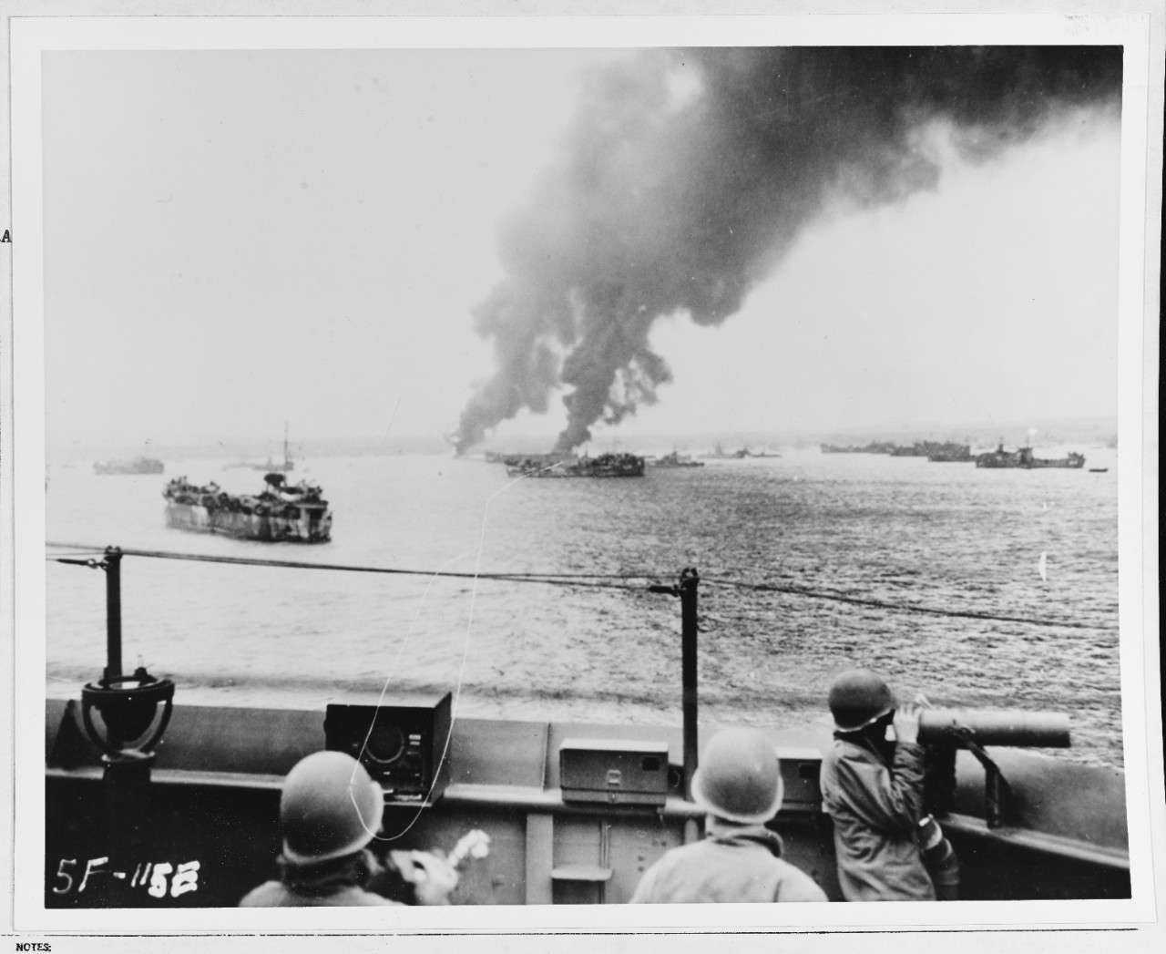 Oil barge on fire off Okinawa, Japan, after air raid, 1945.