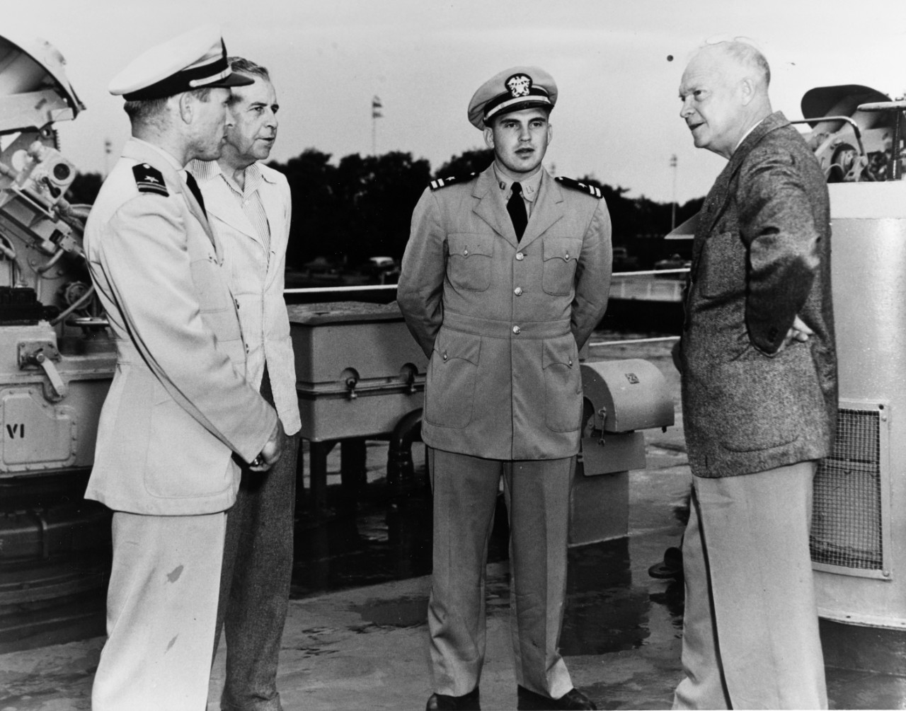 President Dwight D. Eisenhower make a quick inspection on board LSMR-515 after his golf game and before returning to USS Williamsburg, which is tied up at the Santee Dock at the US Naval Academy. Left to right: unidentified ship's officer, Vice Admiral C. Turner Joy, Superintendent of the Naval Academy, Lieutenant C.B. Hood, President Eisenhower