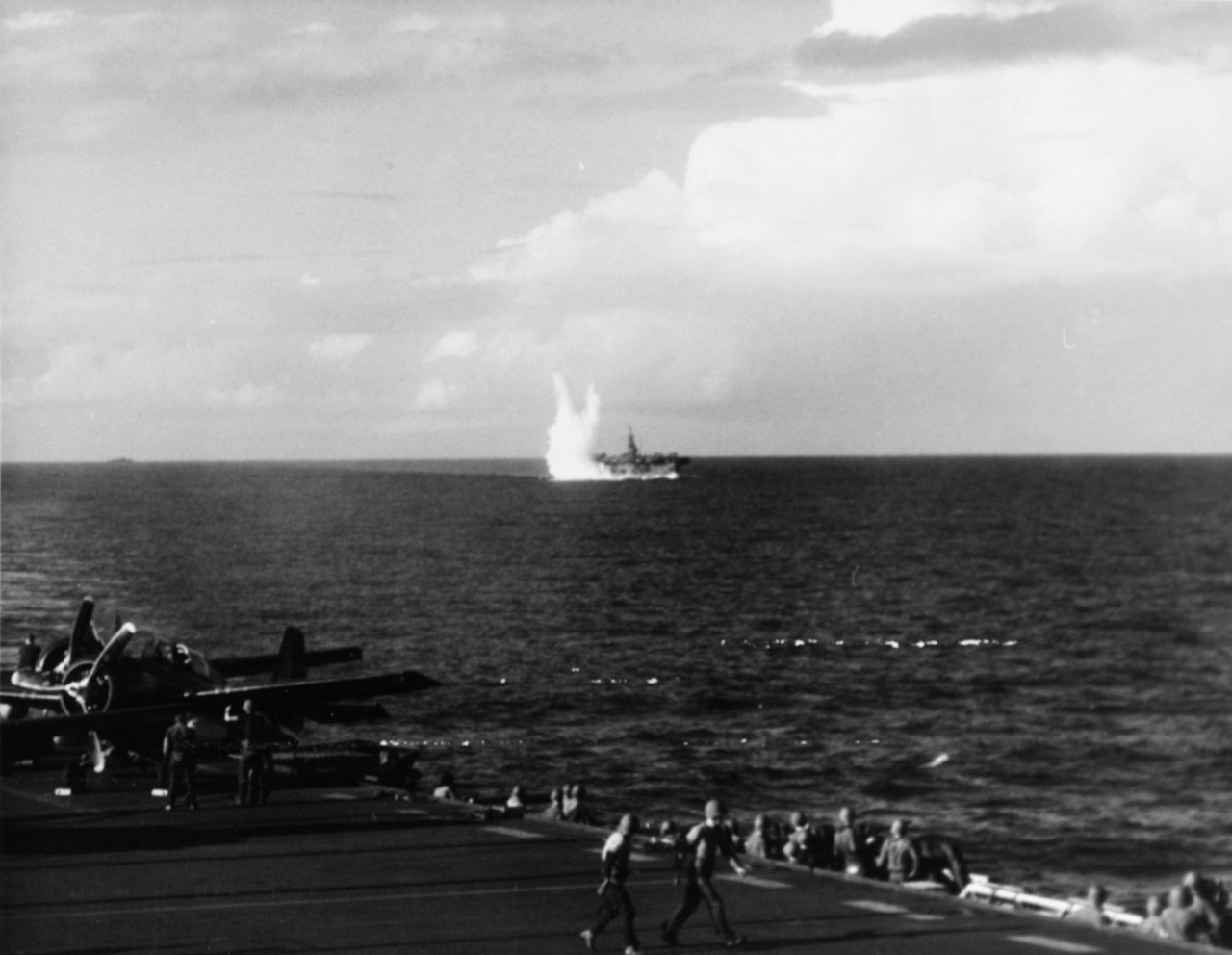 USS Santee (CVE-29) being hit by torpedo, just after being crash dived, 25 October 1944.Taken by USS Petrof Bay (CVE-80) Air Department. 