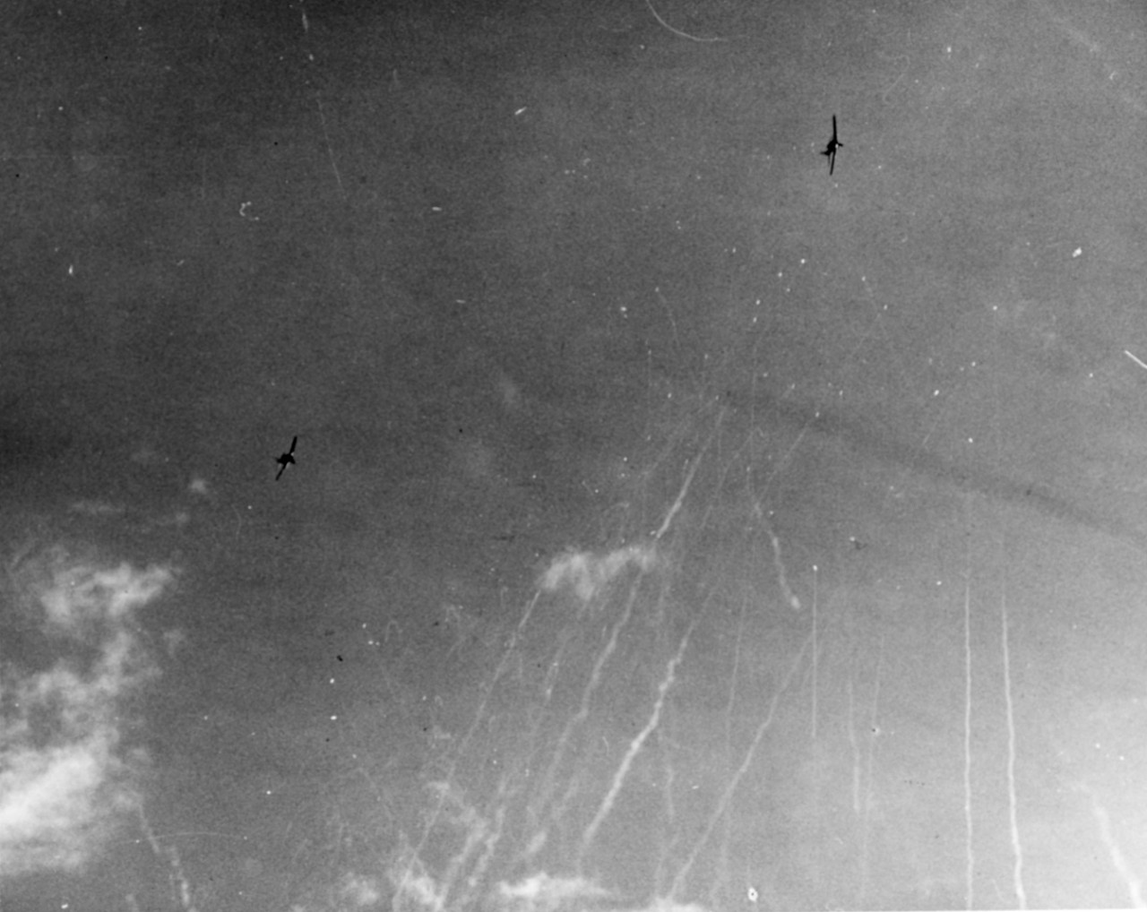 F6F (Ensign Lindskog) is closer (trying to intercept Zeke), but so is USS Suwannee (CVE-27). Note bomb under fuselage, and increasing AA from USS Suwannee. A few seconds later Zeke hit just forward of after elevator, 25 October 1944.