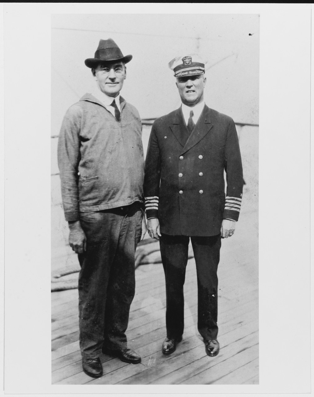 Secretary of the Navy Curtis D. Wilbur (left) and Captain W.D. Brotherton, USN, Commanding Officer of USS MISSISSIPPI (BB-41)