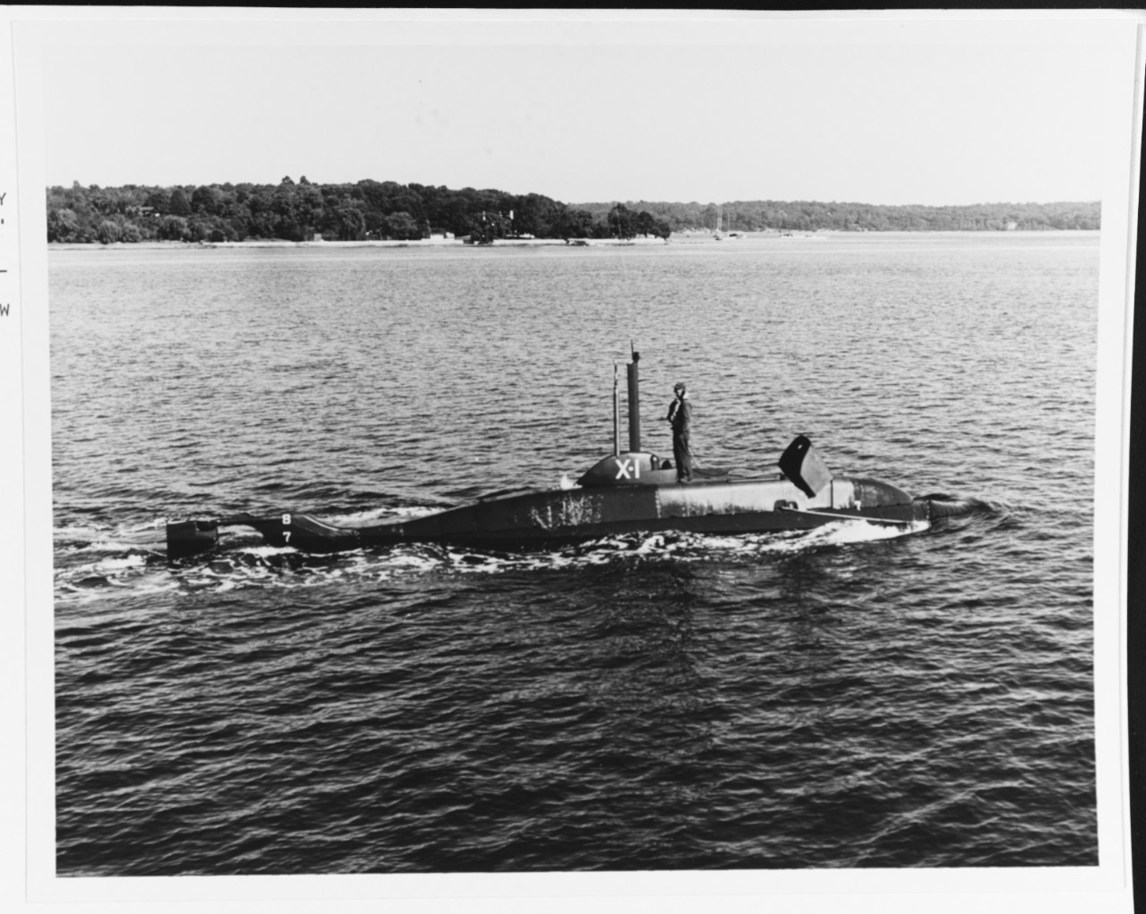 Midget submersible USS X-1 underway on trials in Long Island Sound, 6 October 1955, built by Fairchild Engine and Airplane Corp. Farmingdale Long Island. First Naval vessel designed and constructed by a U.S. aircraft manufacturer. The 25 ton craft is about 50 feet long and has a crew of one officer and four men.