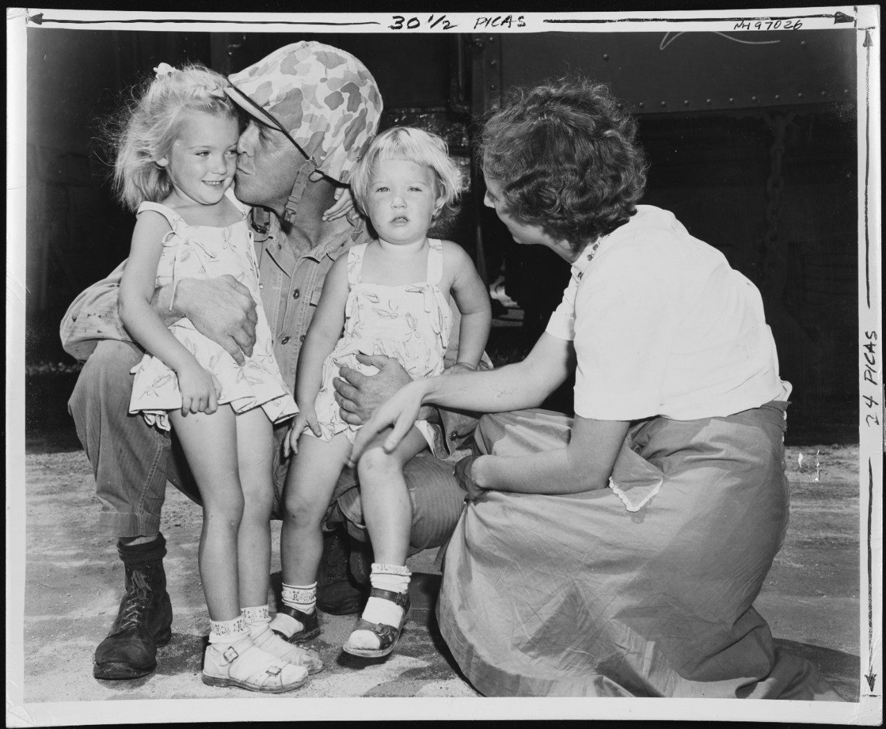 Photo #: NH 97026 "A Marine bids farewell to his wife and two daughters as elements of the famed Second Marine Division leave for the West Coast"