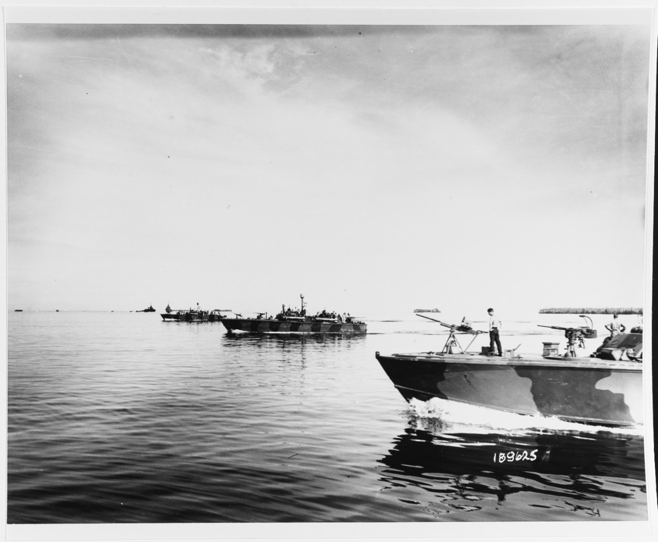Admiralties Operations, March-April 1944. PT boats bombarding Pityilu Island, Seeadler Harbor, prior to landings there by the Army's First Cavalry Division