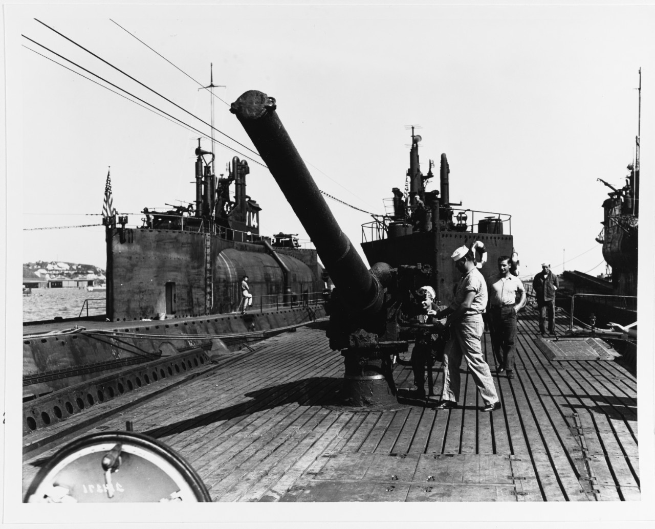 I-400 (Japanese Submarine, 1944). View of the after 5.5" deck gun, with U.S. Navymen S1c Rudolph Massengill and Torp. 1c Willis Clement. October 14, 1945
