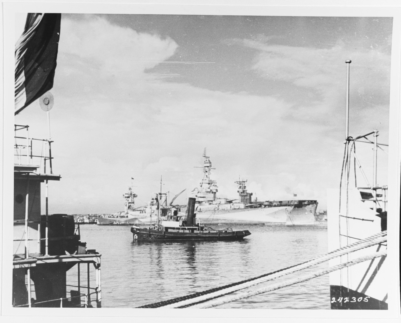 USS AUGUSTA (CA-31) in Casablanca Harbor, Morocco, November 12, 1942. A French tug is in the foreground