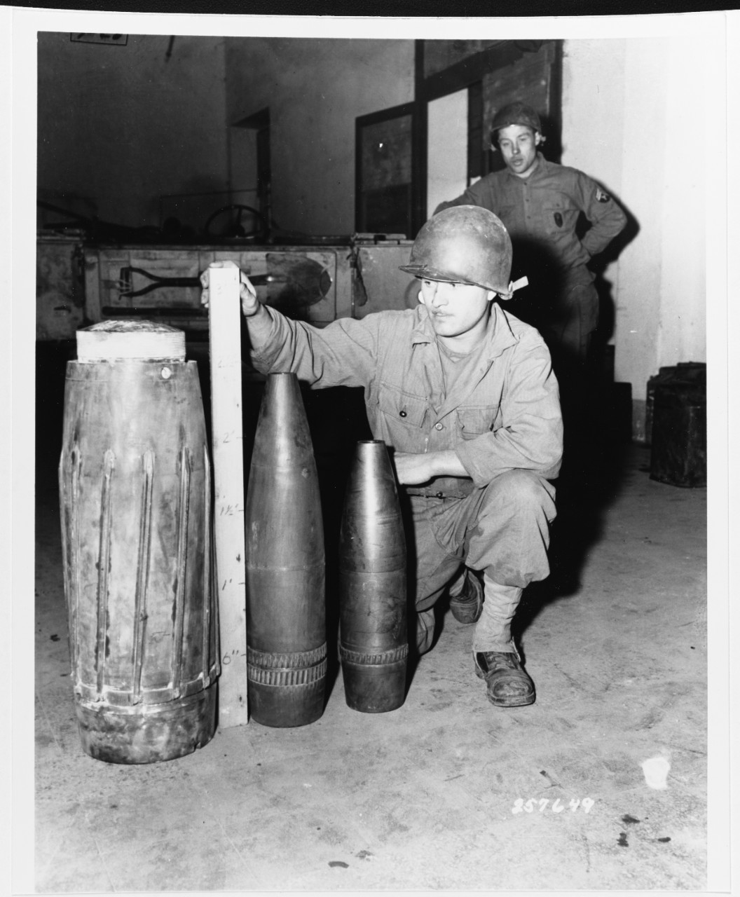 Private John B. Folstrom measures German shells, Anzio Beachhead, April 11, 1944