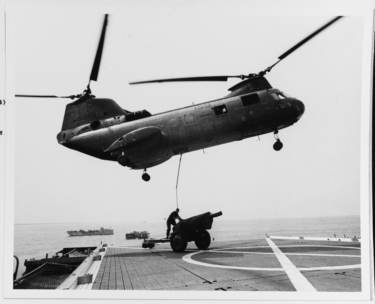 An H-46 Sea Knight helo prepares to lift a 105mm Howitzer from the deck of the USS MONTICELLO (LSD-35)