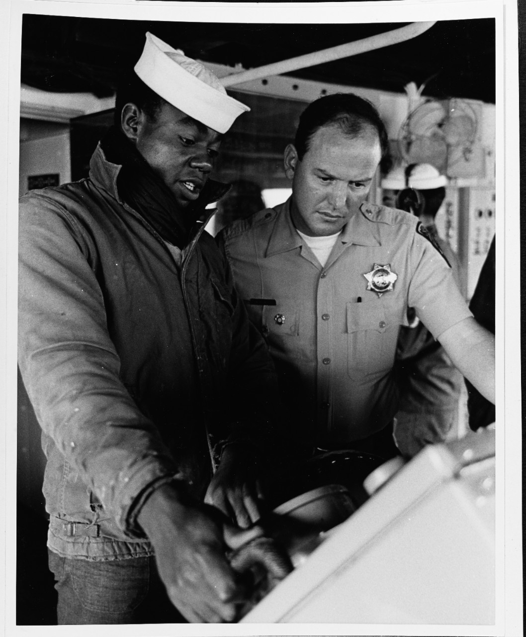 Seaman aboard the USS BRONSTEIN (DE-1037) teaches seagoing "rules of the road."