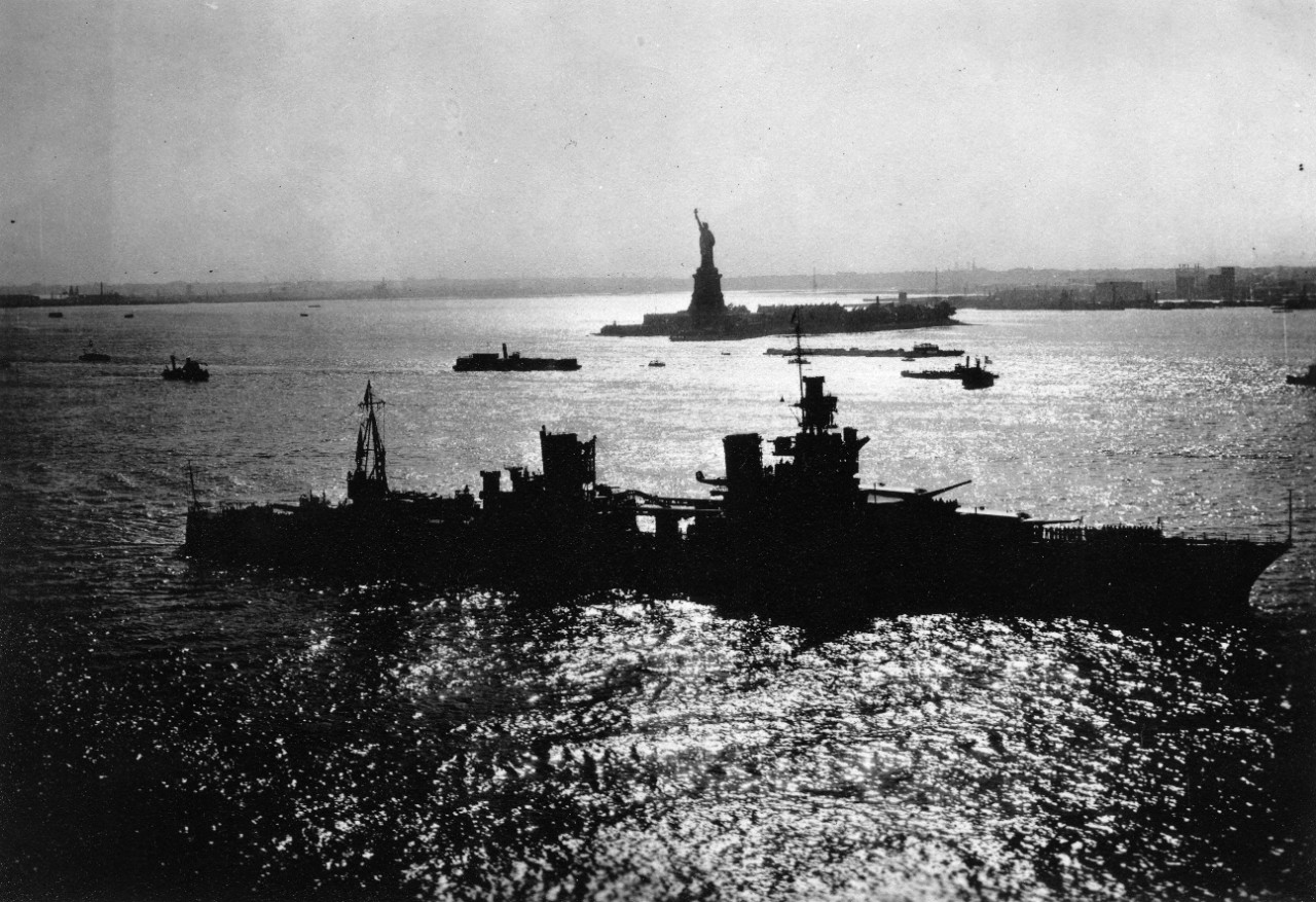 USS Indianapolis (CA-35) at New York City, circa 1930's. The Statue of Liberty can be seen in the background.