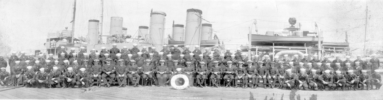 Officers and crew of USS Borie (DD-215) pose alongside their ship at Norfolk Navy Yard, VA, 1921.