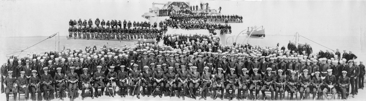 Officers and crew of USS Oklahoma (BB-37) posing aboard their ship, 1930. Commanding officer CPT S.F. Hellweg is in the center of the front row.